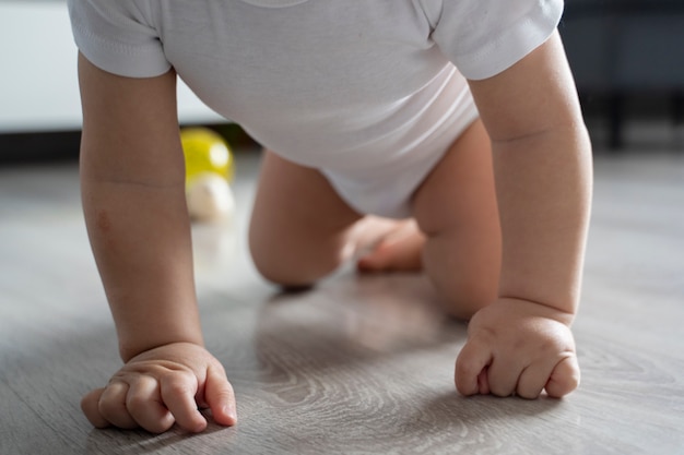 Low angle cute baby crawling on floor