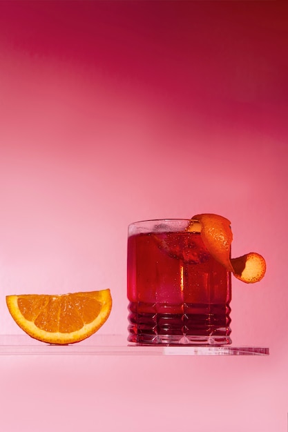 Low angle delicious negroni with pink background