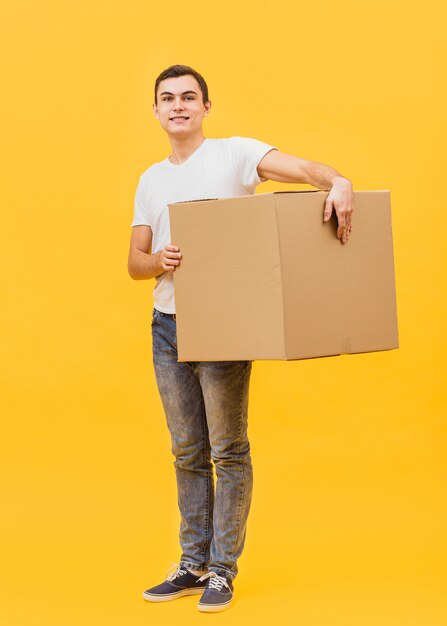 Low angle delivery man holding package