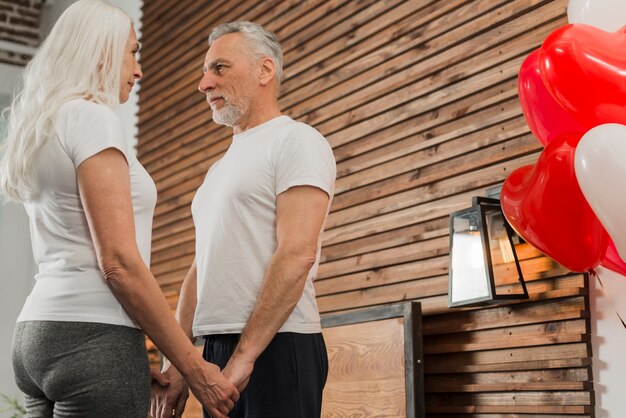 Low angle elderly couple holding hands