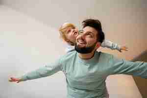 Free photo low angle father playing with boy