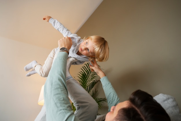 Low angle father playing with boy