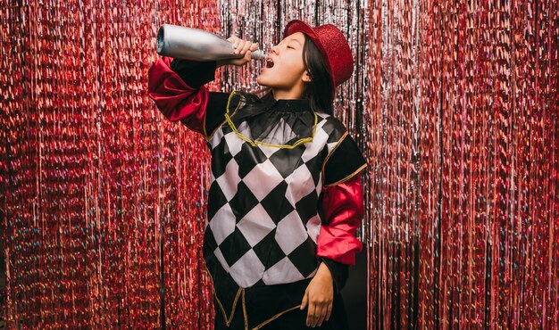 Low angle female in costume with champagne bottle