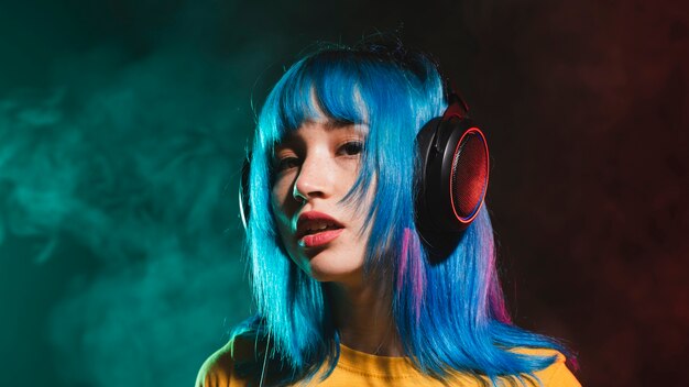 Low angle female dj in club with headphones