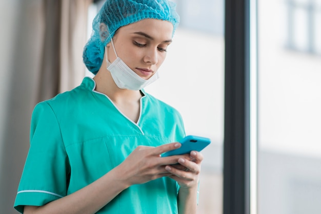 Low angle female nurse with mobile