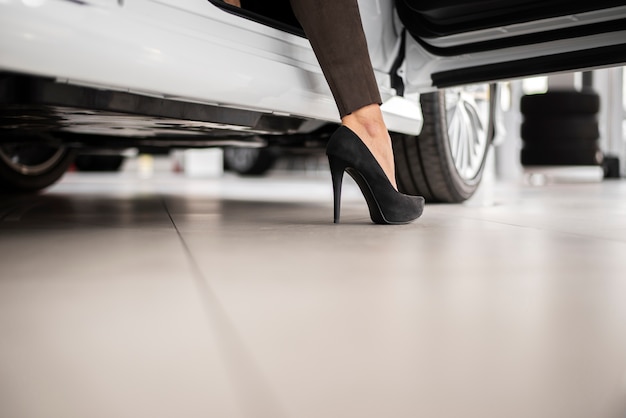 Low angle female selling cars