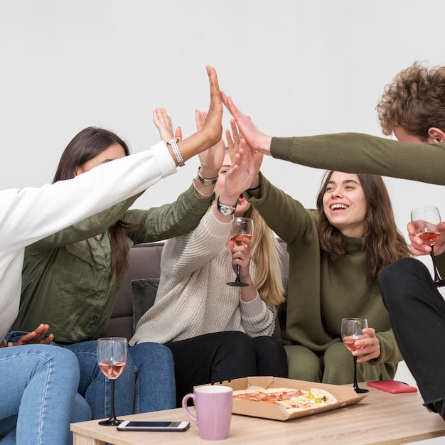 Free photo low angle friends giving high five