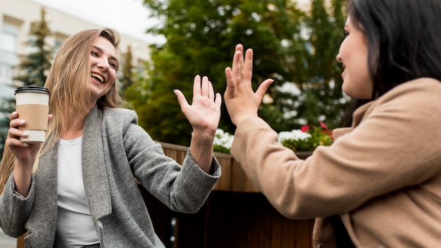 Low angle friends high fiving