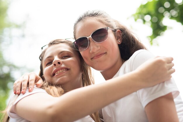 Low angle friends hugging 