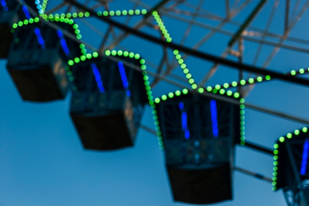 Low angle giant wheel with blue sky