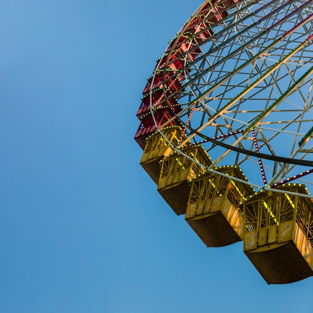 Low angle giant wheel with blue sky