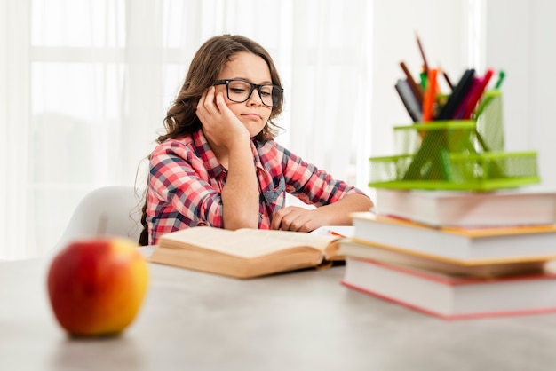 Low angle girl with glasses studying