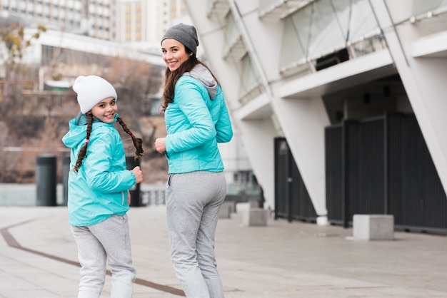 Low angle girl with mom running