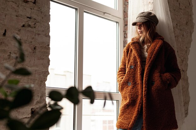 Low angle girl with warm coat and hat