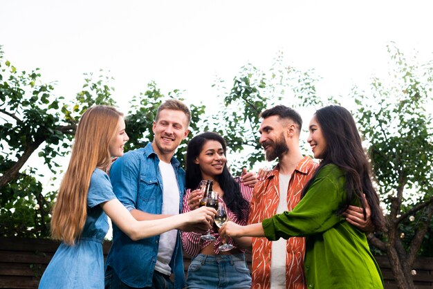 Low angle group of friends together with drinks