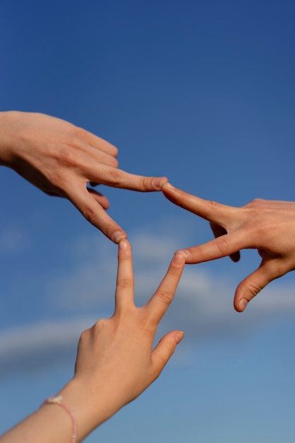 Free photo low angle hand gestures representing friendship