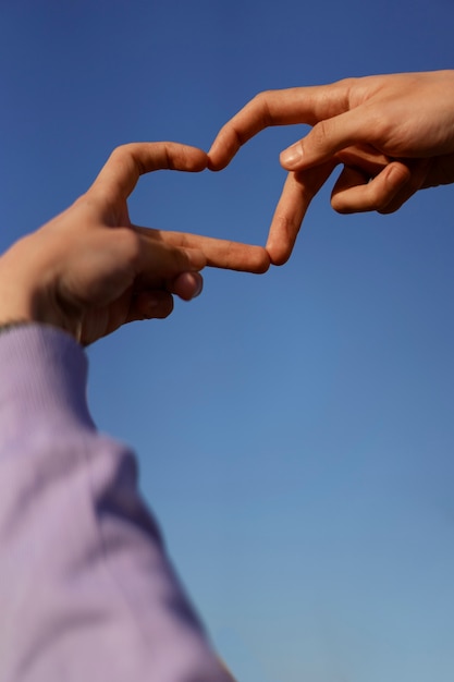 Foto gratuita gesti delle mani ad angolo basso che rappresentano l'amicizia