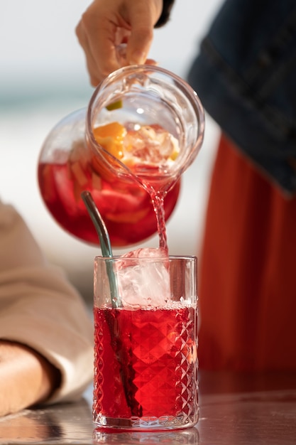 Low angle hand pouring sangria