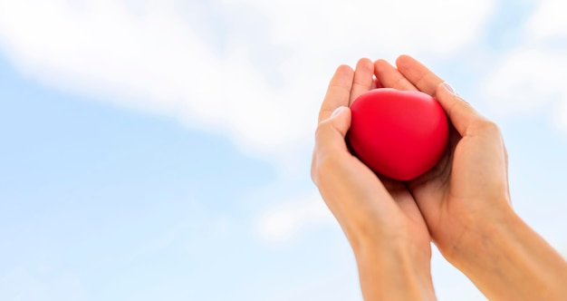 Low angle of hands holding heart shape with copy space