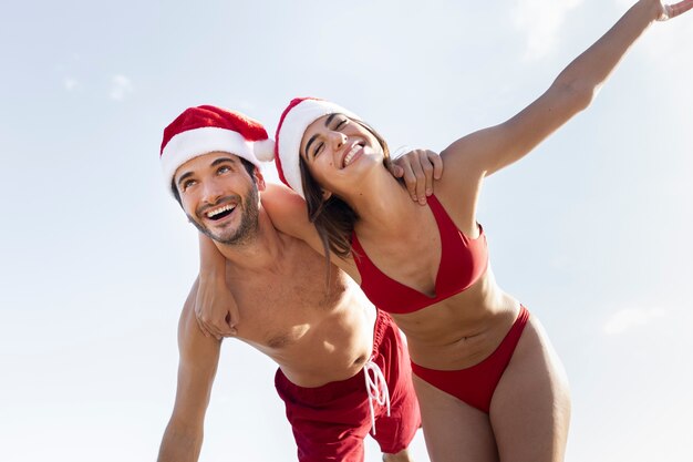 Low angle happy couple with santa hats