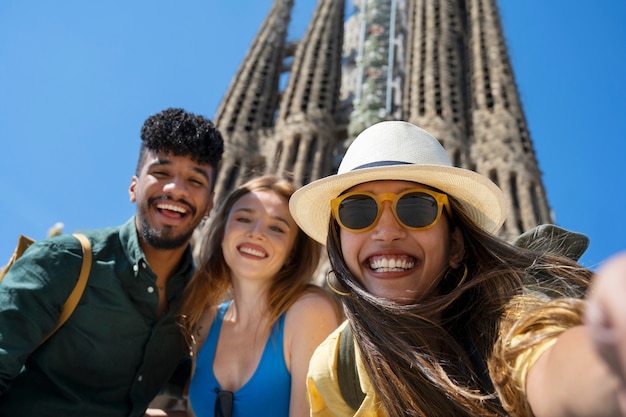 Free photo low angle happy friends posing