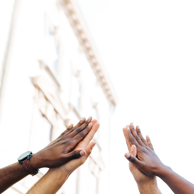 Low angle intercultural hands united 