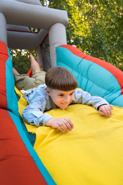 Low angle kid sliding in bounce house