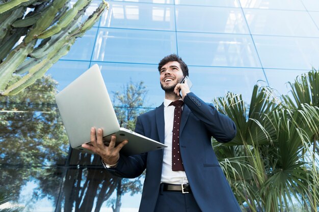 Low angle lawyer holding his laptop