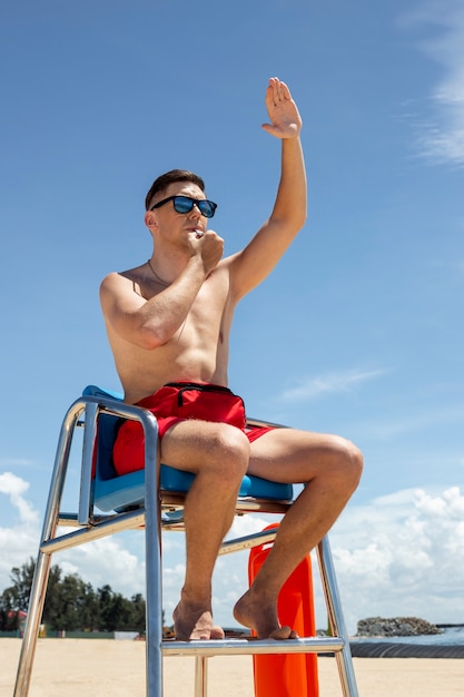 Low angle lifeguard sitting on chair