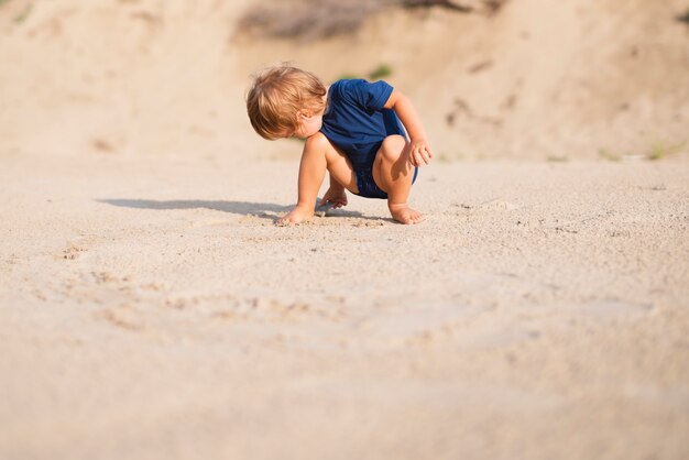 Low angle little boy at beach playing