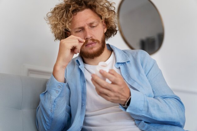 Low angle man holding anxiety pills