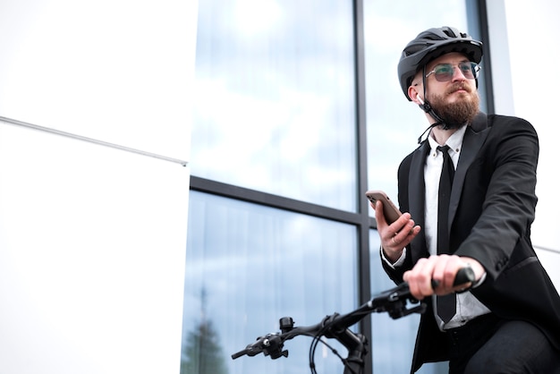 Low angle man holding smartphone