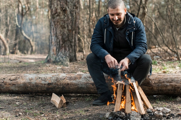 Low angle man making bonfire