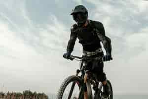 Free photo low angle man in mountain biking equipment