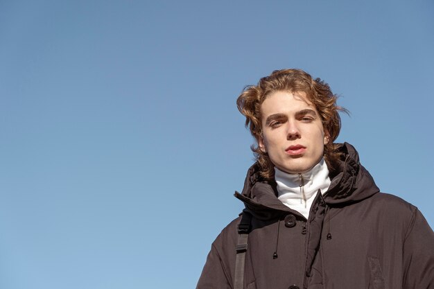 Low angle of man posing against the sky