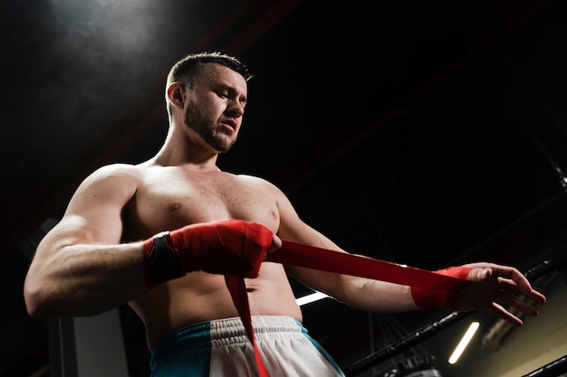 Low angle man training in boxing ring