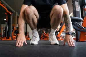 Free photo low angle man training at gym