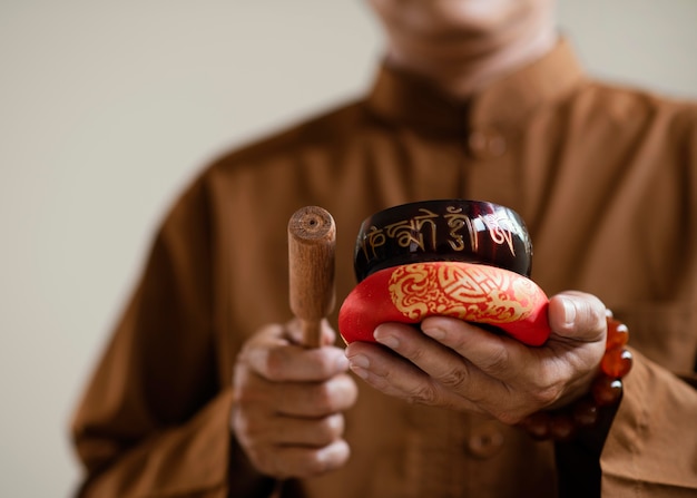 Free photo low angle of man with singing bowls