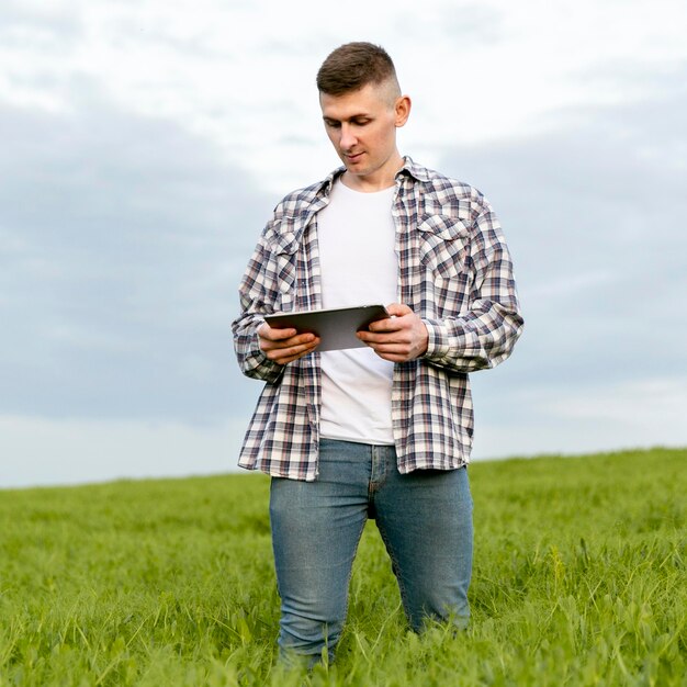 Low angle man with tablet