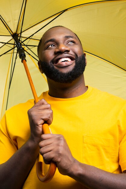 Low angle man with umbrella