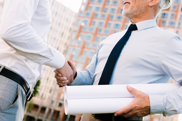 Low angle men shaking hands