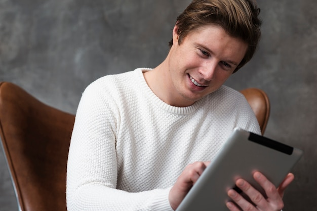 Low angle modern man working on tablet