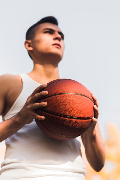 Free photo low angle of motivated basketball player