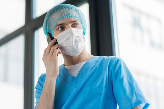 Low angle nurse talking over phone