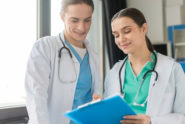 Low angle nurses looking at clipboard