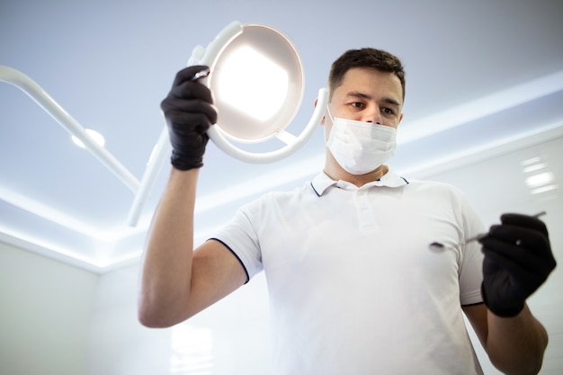 Low angle of orthodontist starting a procedure