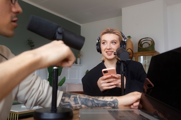 Low angle people recording podcast