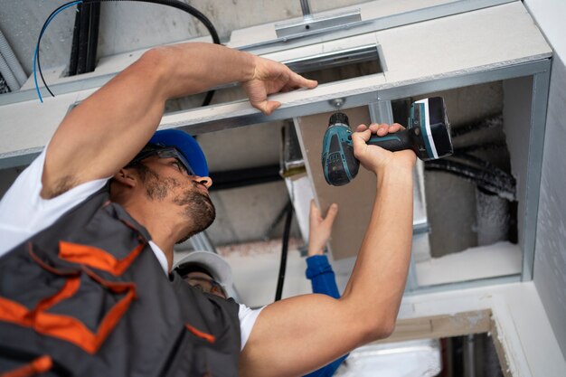 Low angle people working with drill