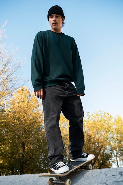 Low angle rebel teen on skateboard