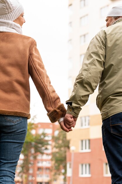 Low angle senior couple holding hands